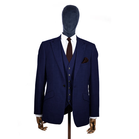 Brown Knitted tie and pocket square with navy suit on a mannequin - centre