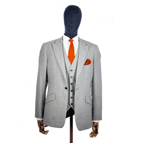 Burnt Orange Knitted tie and pocket square with grey suit on a mannequin - centre