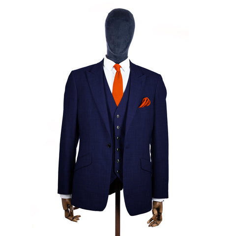 Burnt Orange Knitted tie and pocket square with navy suit on a mannequin - centre