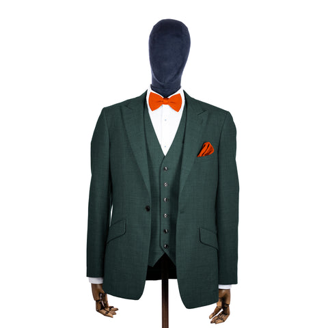 Burnt Orange knitted bow tie and pocket square with green suit on a mannequin-BroniandBo