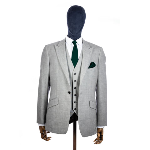 Green Knitted tie and pocket square with grey suit on a mannequin - centre