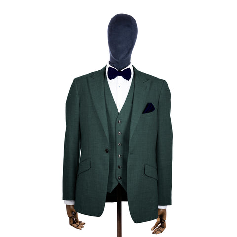 Ink Blue knitted bow tie and pocket square with green suit on a mannequin-BroniandBo