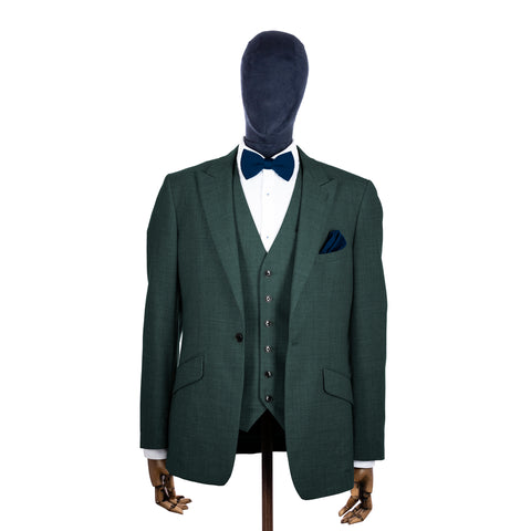 Midnight Blue knitted bow tie and pocket square with green suit on a mannequin-BroniandBo