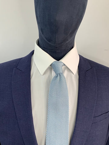 Misty blue knitted tie and navy suit