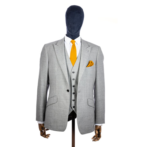 Mustard Yellow Knitted tie and pocket square with grey suit on a mannequin - centre