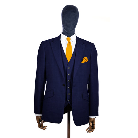 Mustard Yellow Knitted tie and pocket square with navy suit on a mannequin - centre