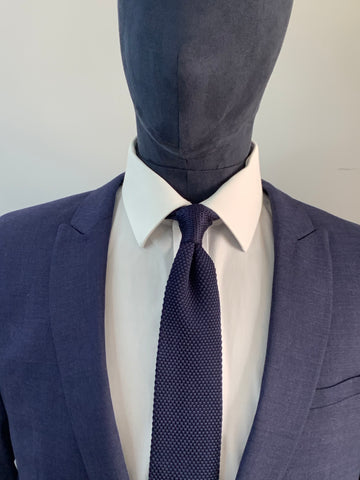 Navy blue knitted tie and navy suit
