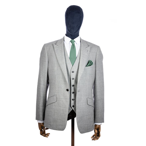 Sage Green Knitted tie and pocket square with grey suit on a mannequin - centre