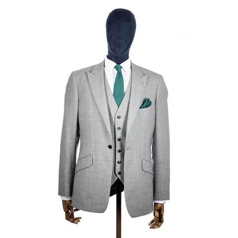 Teal Knitted tie and pocket square with grey suit on a mannequin - centre
