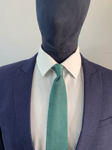 Teal knitted tie and navy suit