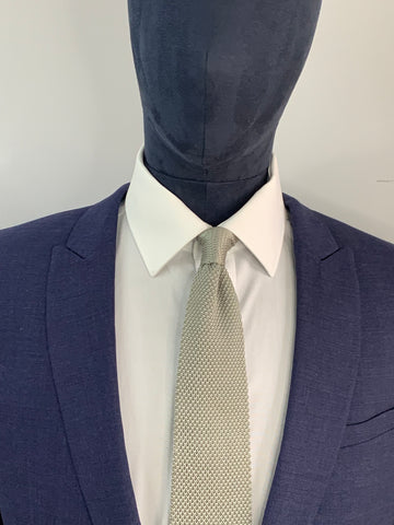 Stone grey knitted tie and navy suit