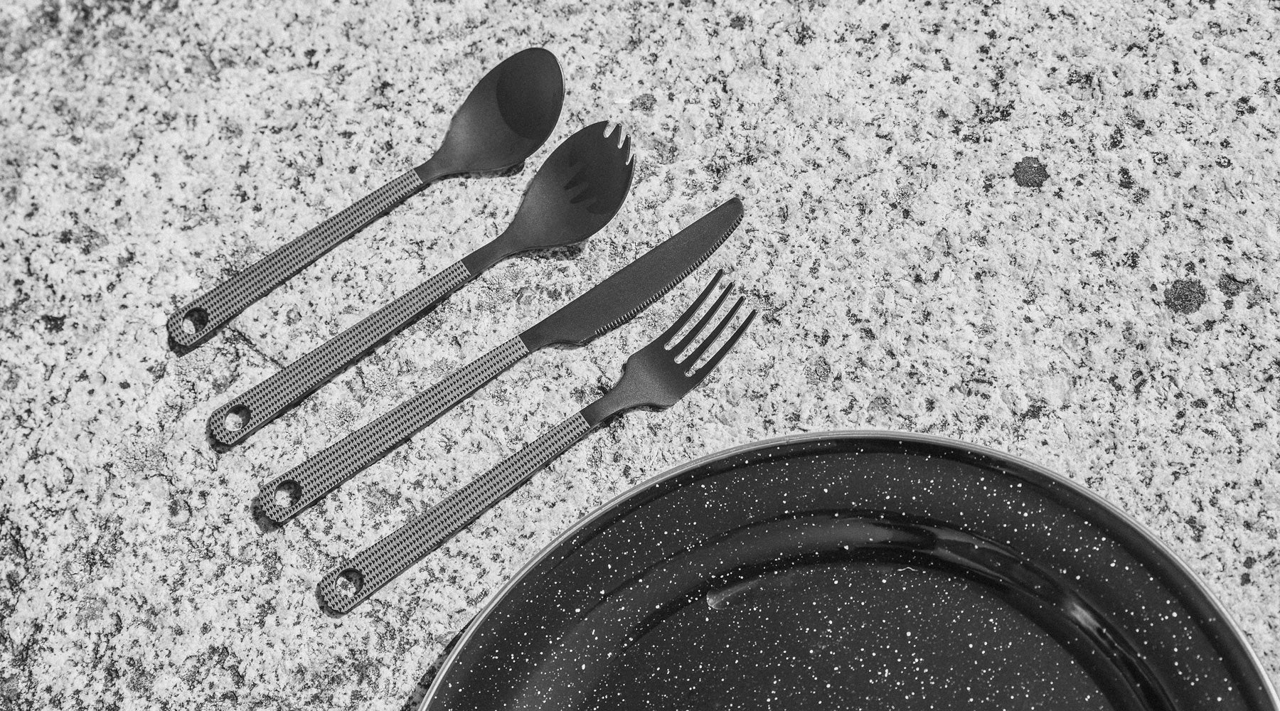 so ill x on the roam cutlery set shown on climbing rock with a plate