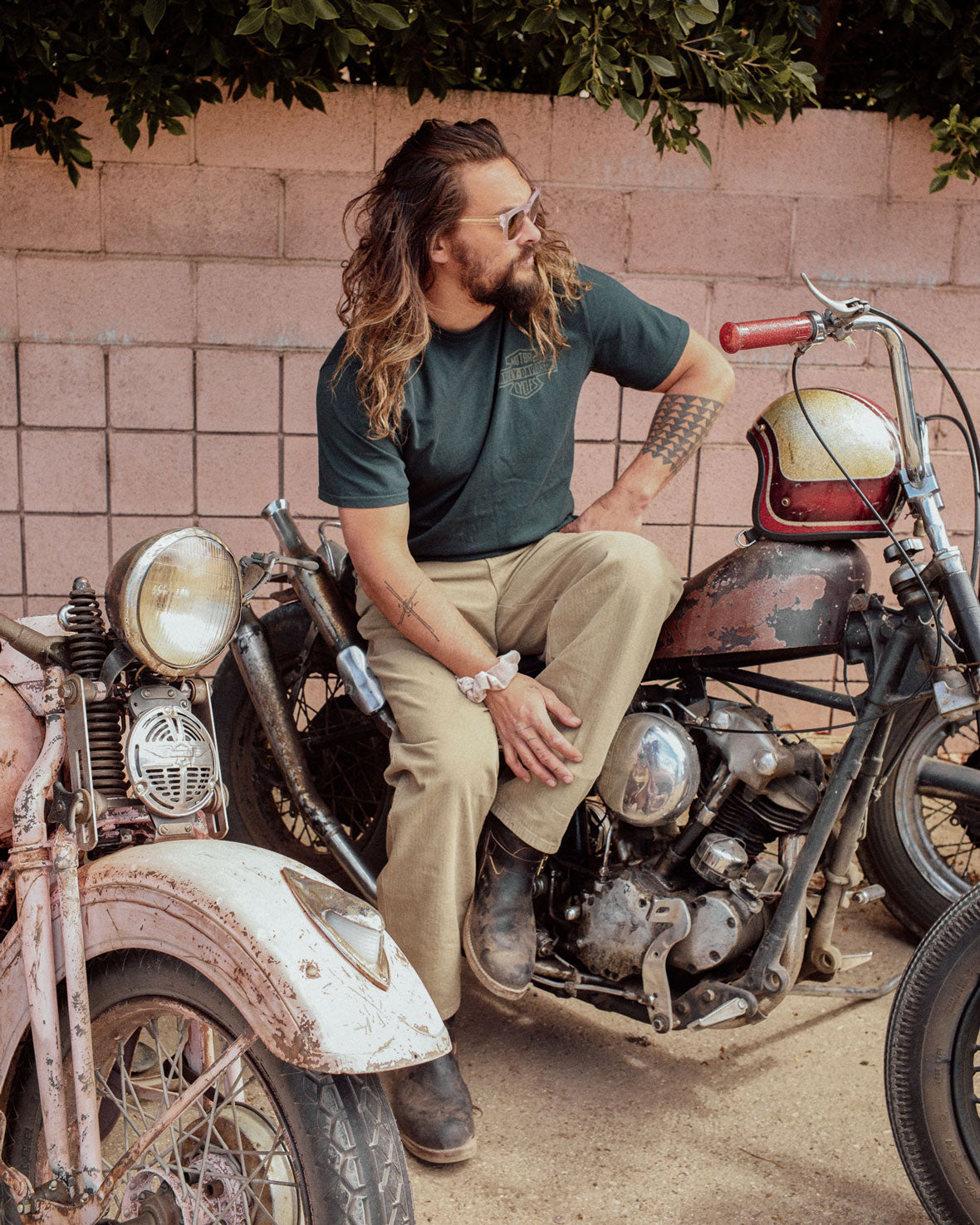 the so ill x on the roam scrunchies being shown on jason momoa while he sits on a harley