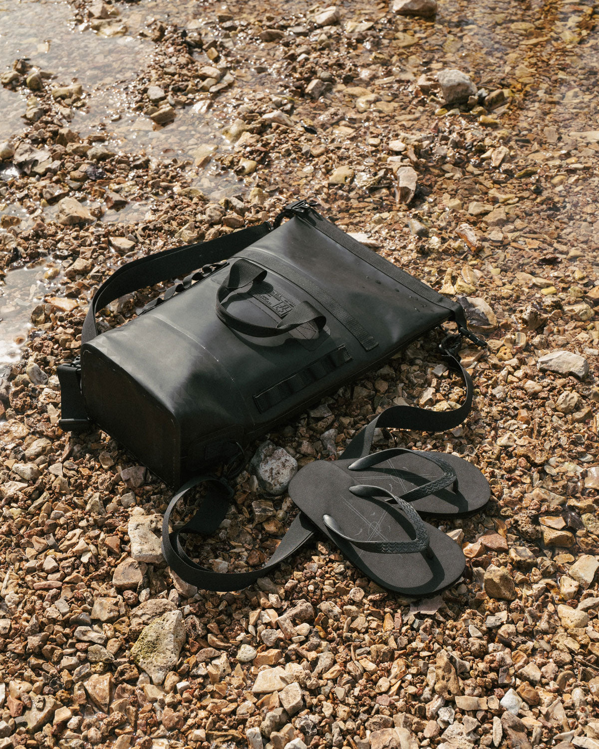 Jason Momoa's on the roam x so ill kanakas pictured in a creek bed with the 25L dirt bag