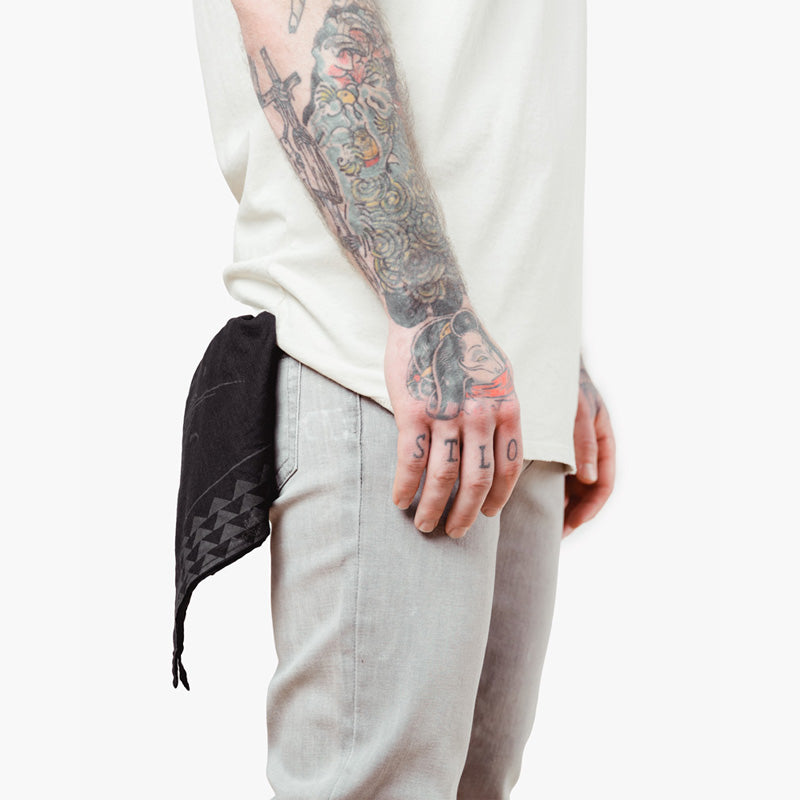 a man uses the so ill x on the roam bandana as a pocket square