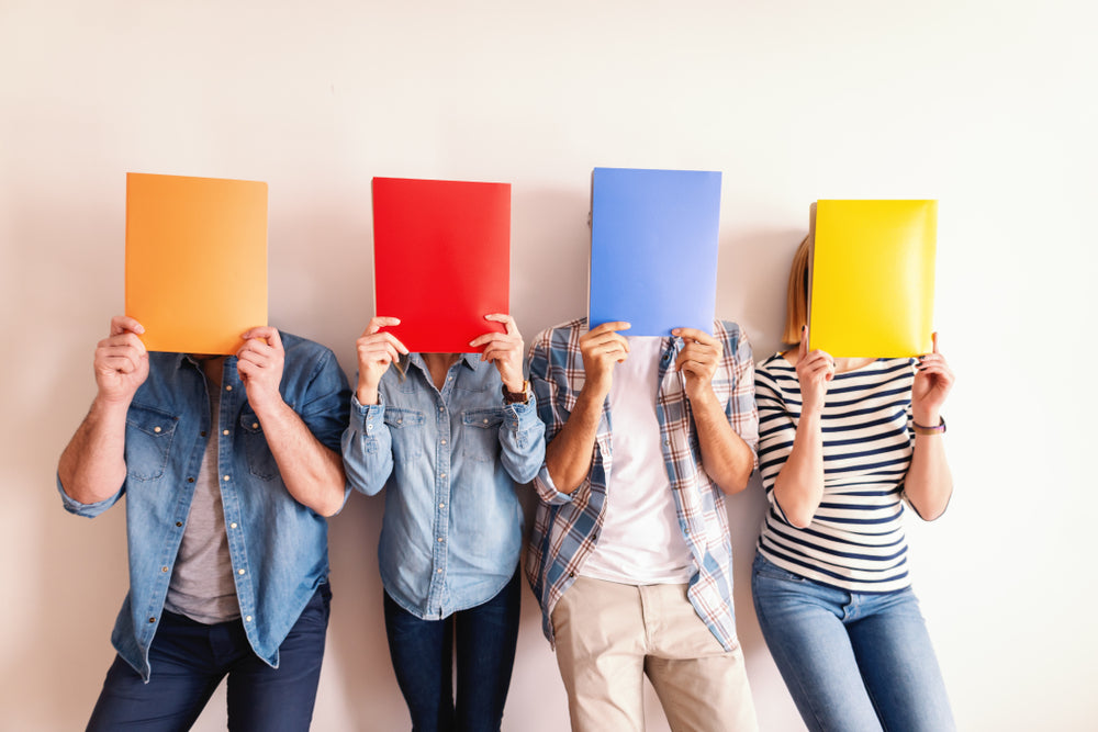 Student Covering Their Face With Folders