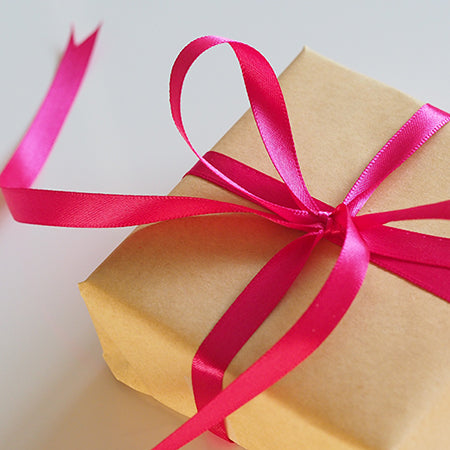 Gift, wrapped and tied with pink ribbon