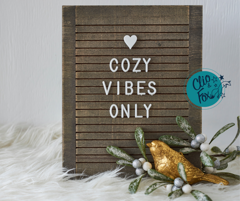 Wood letter board with the message "Cozy Vibes Only" with a gold bird and mistletoe