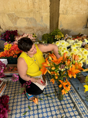 Jennifer Gandia working on a floral arrangement at a floral design workshop 