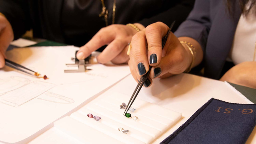 Hands using tweezer and measuring gemstones