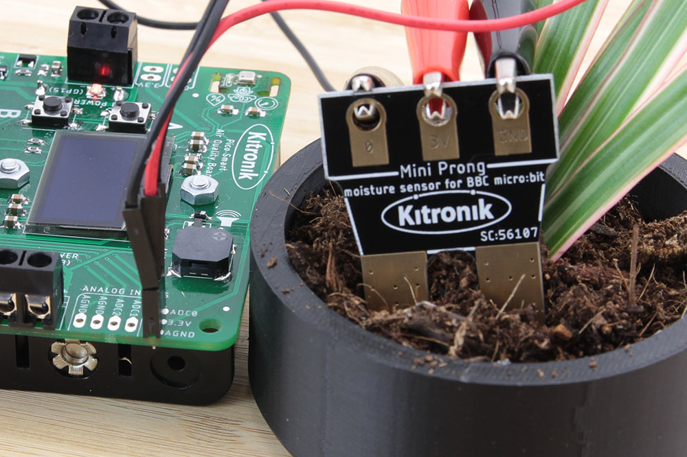 Close up image of Mini Prong in plant pot connected to main board with croc clip leads