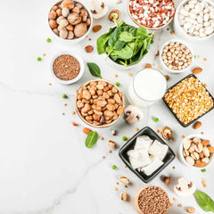 healthy food on a white table nuts and grains scattered around