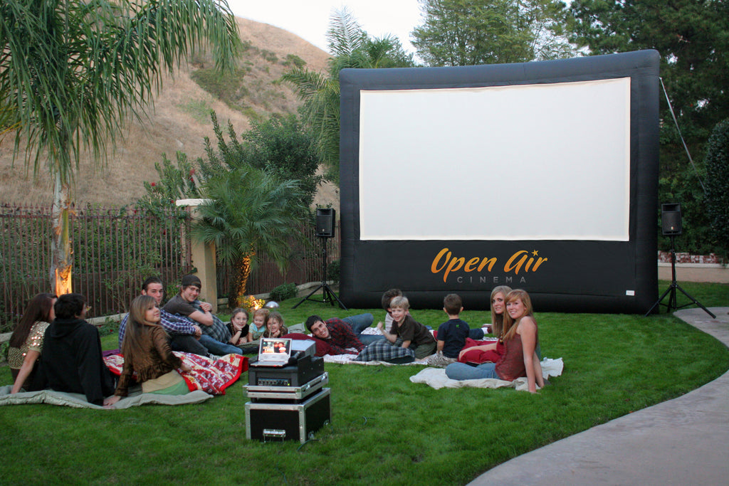 Family gathering around outdoor Movie Screen