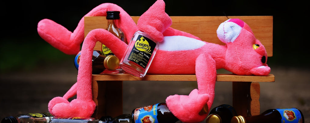 Decadent character surrounded by alcohol bottles