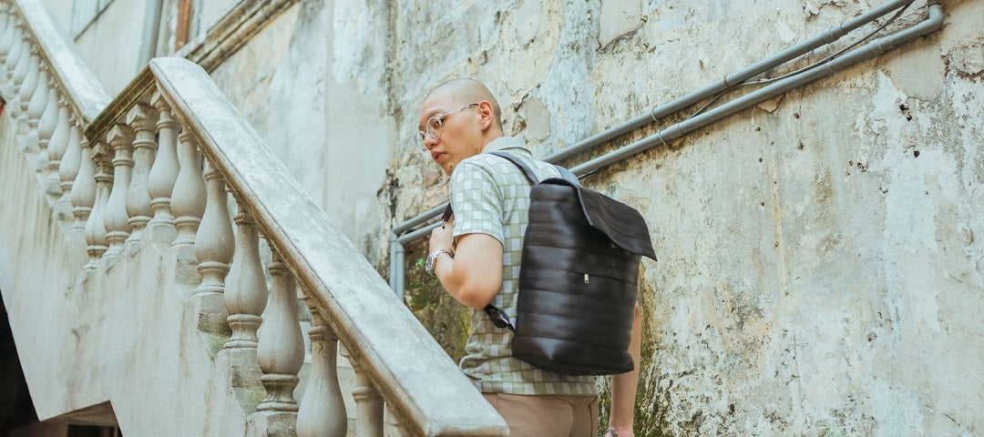 gifts for commuters - man going up stairs wearing backpack