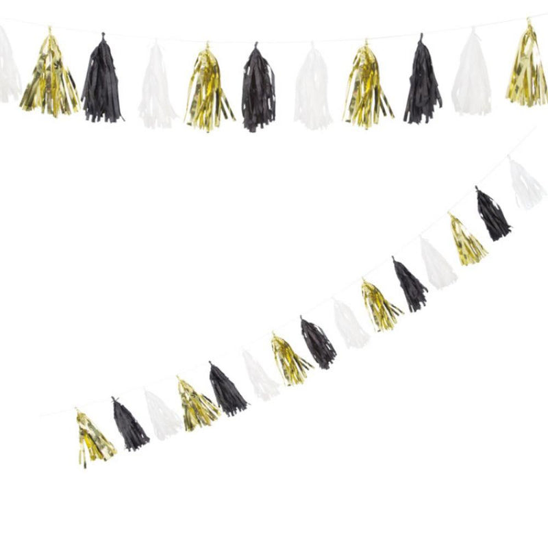 A metallic gold, black, and white tassel party garland