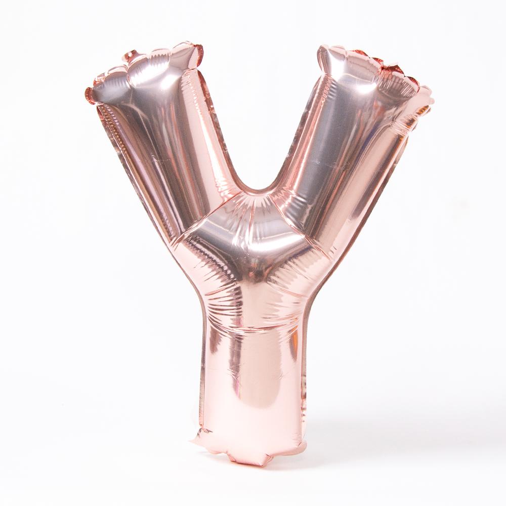 A rose gold foil balloon in the shape of the letter "Y"