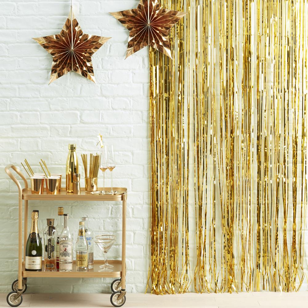 Click to view product details and reviews for Fringe Backdrop Shimmery Gold.