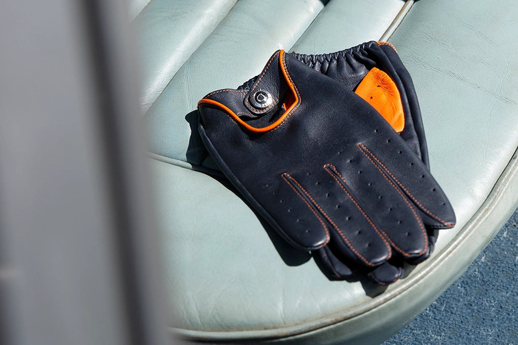black leather driving gloves on vintage leather car seat