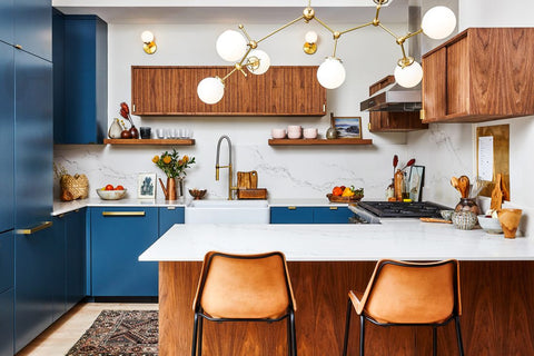 Brass and glass Chimie Chandelier light fixture by Sazerac Stitches in open blue, white and wood modern kitchen
