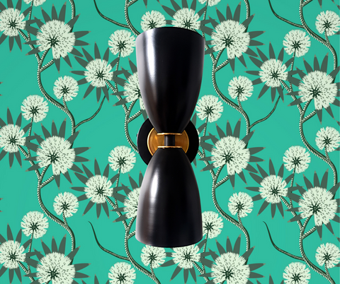 Green wallpaper with black sconce