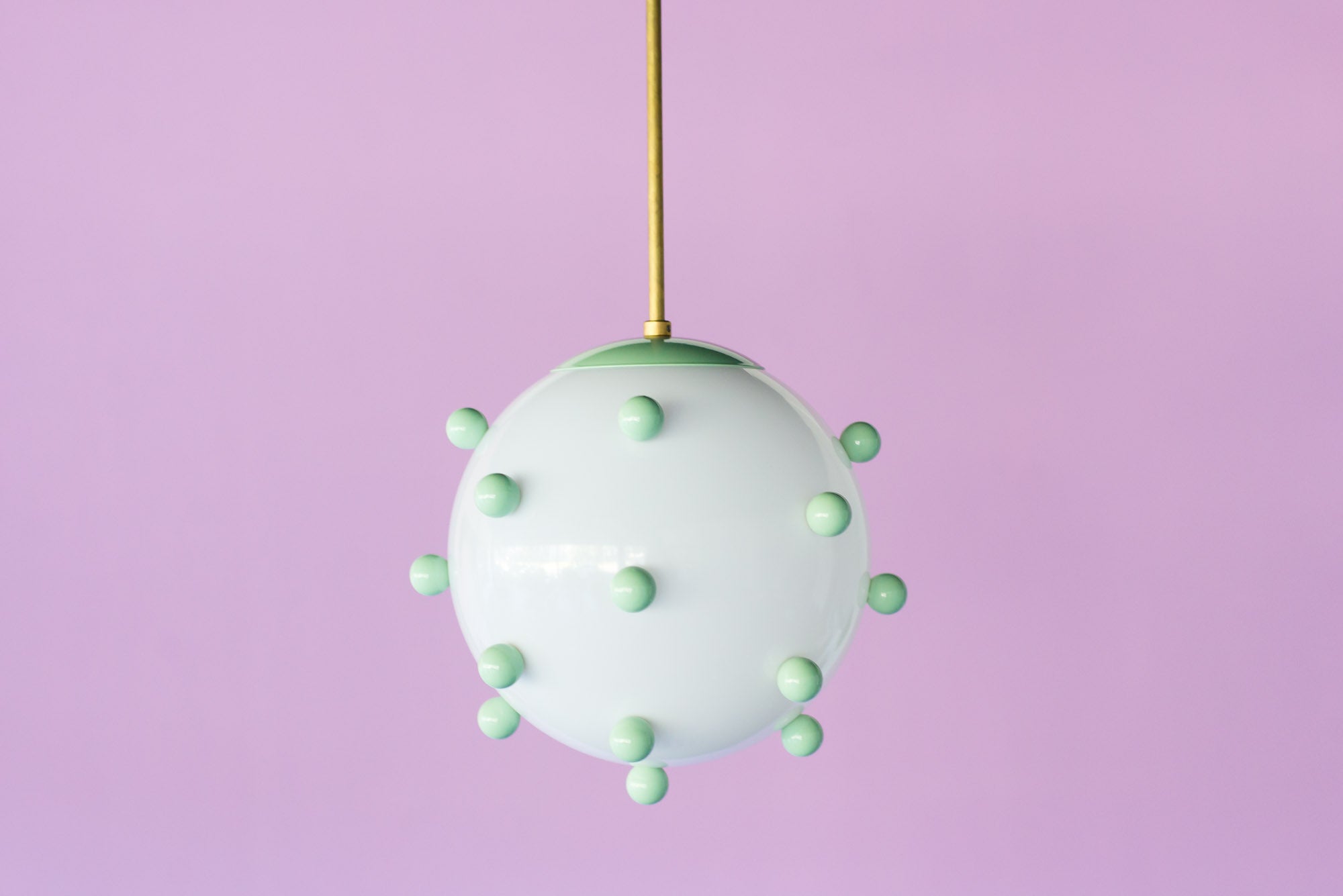 Colorful Gumball chandelier in pastel blue on a purple wall