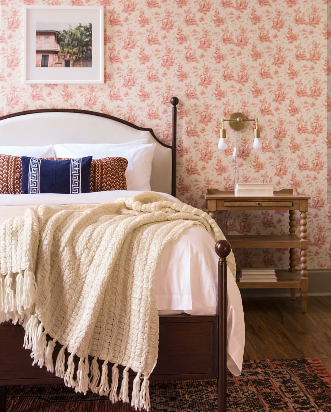 Peach Bedroom with neutral tones and a pop of navy