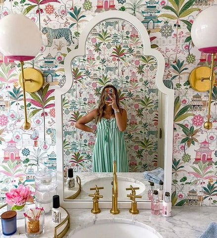 Floral Bathroom wallpaper with Verbena Sconces and a white arched mirror