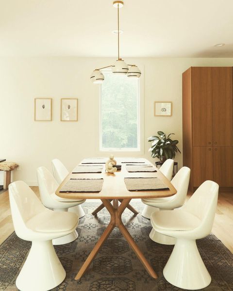 Clean and crism dining room featuring ceramic Delta Chandelier