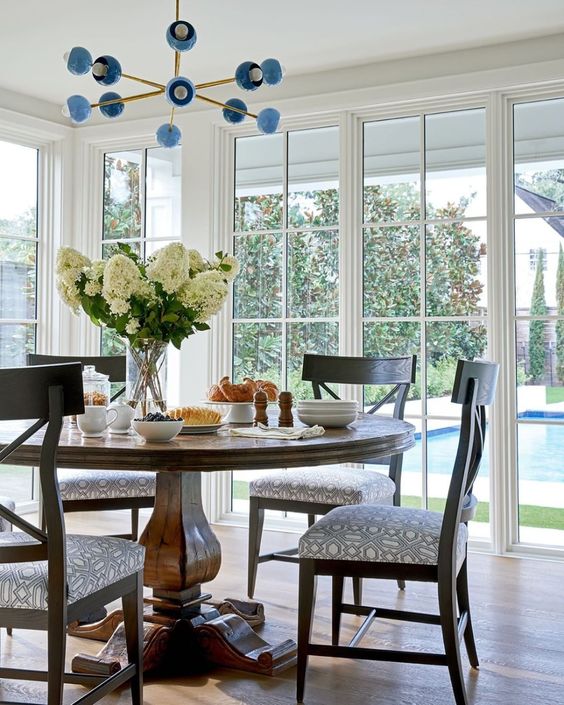 Traditional dining room with a sputnik style blue and brass Orion chandelier by Sazerac Stitches