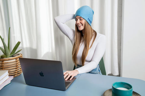 woman relieving headache with IceBeanie cold beanie for headache relief head pain cold hat relief