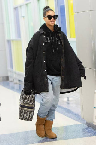 Rihanna wears an oversized denim shacket and her UGG boots in a perfect 'celeb-off-duty' look.
