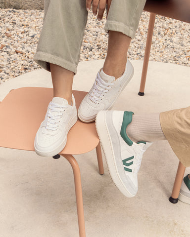 The Sonder white grey and The Misfit white grey green sneaker in a salmon chair