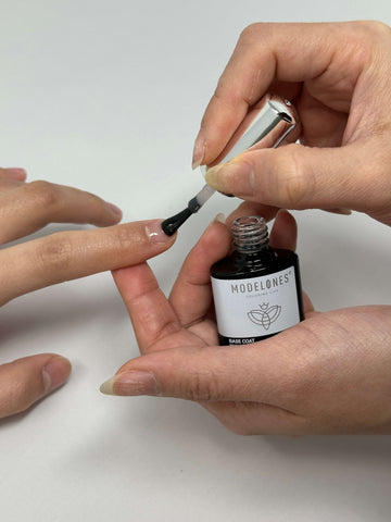 Applying Modelone's base coat on nails