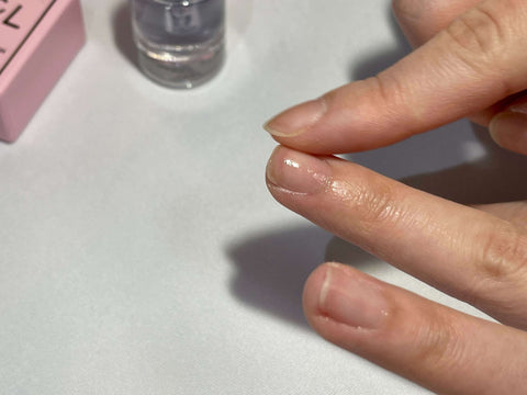 Massaging cuticle oil to restore moisture to cuticle