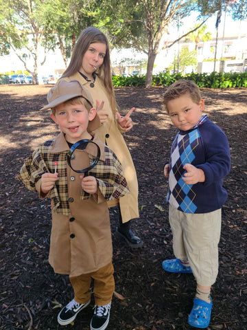 A young girl and two boys doing a team building game