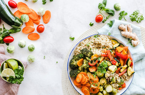 Vegetable bowl with quinoa next to other vegetables