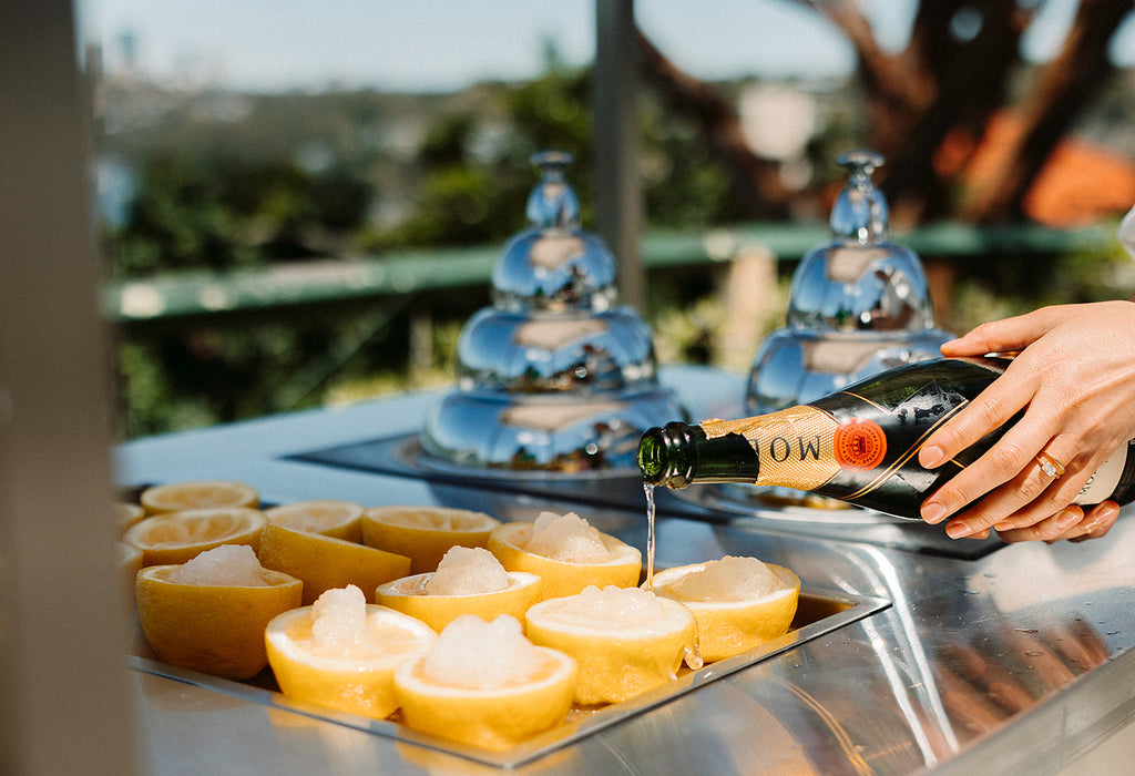 Champagne is poured into lemon granita served in half lemons 