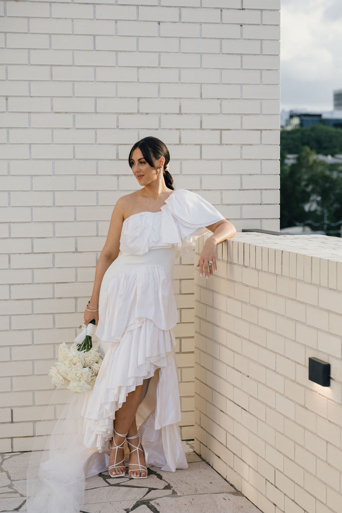 Ally stands on the Calile rooftop at her wedding 