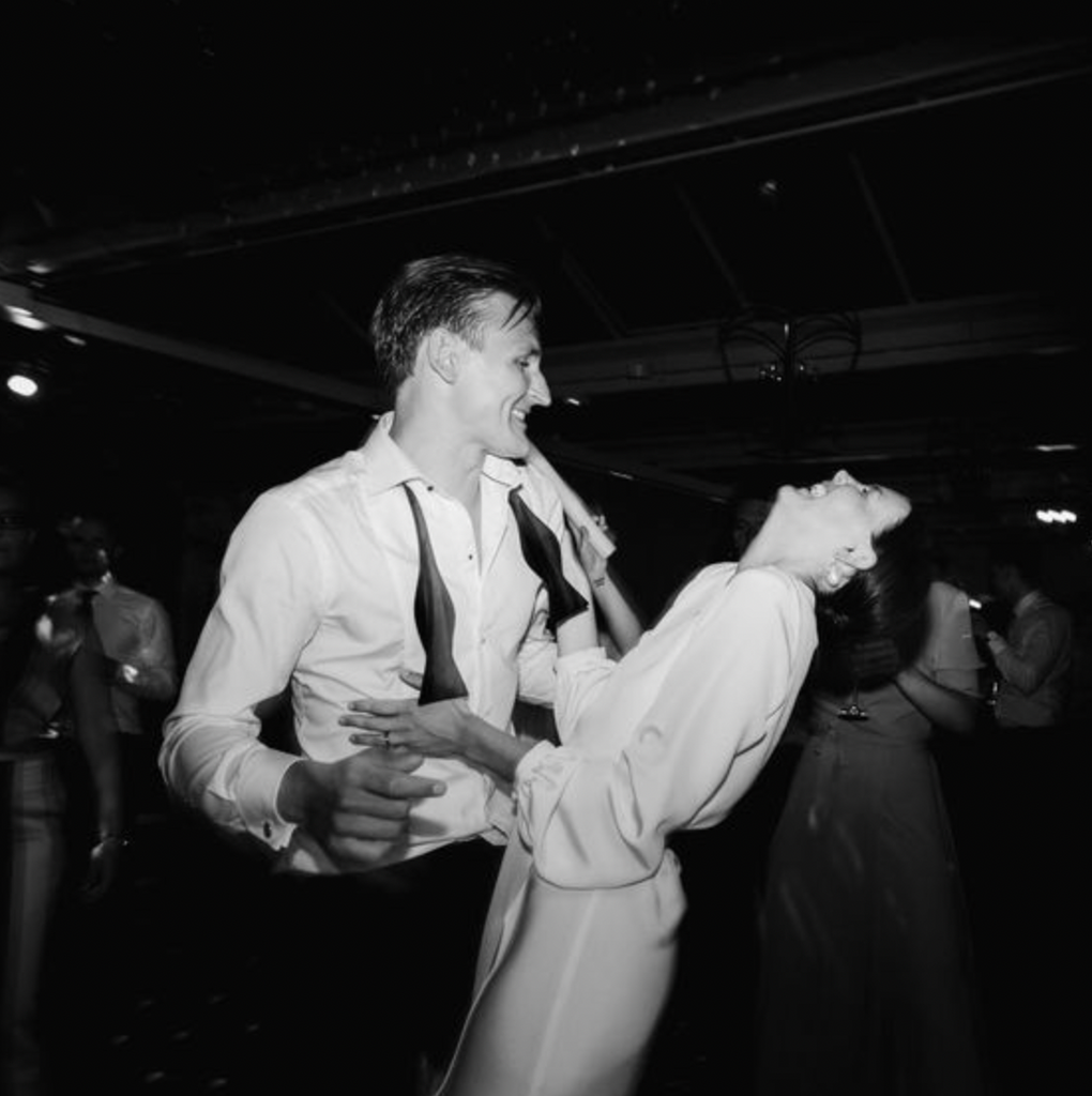 Black and White Image with a happy laughing couple at their wedding during their first dance together as husband and wife